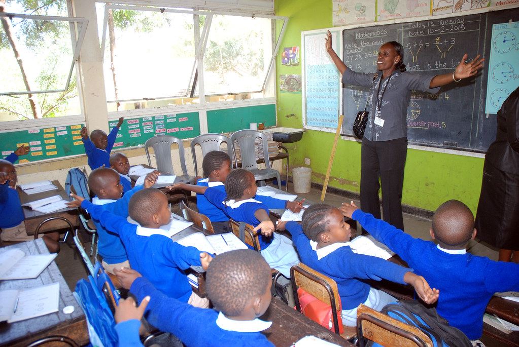 Pupils raising hands in a classroom